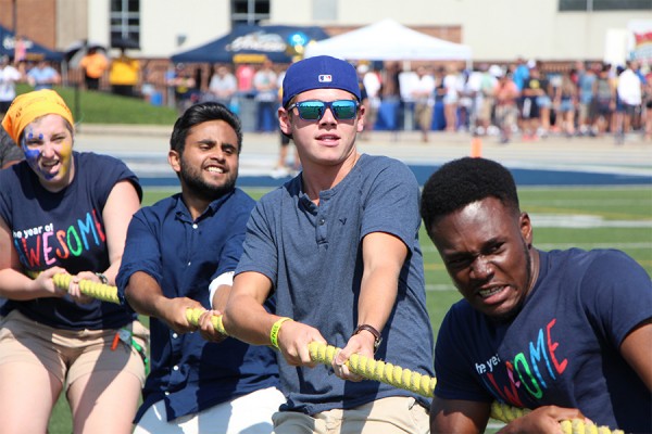 Competitors in a tug-of-war do their part on Alumni Field during the 2016 Lancer football home opener.