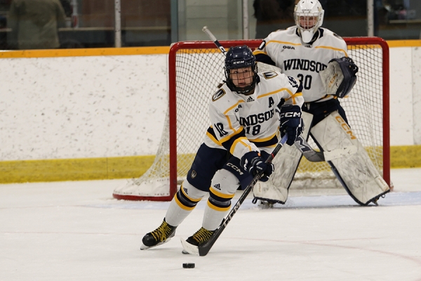 hockey player carries the puck