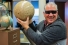 Astronomer Steve Pellarin holding lunar globe