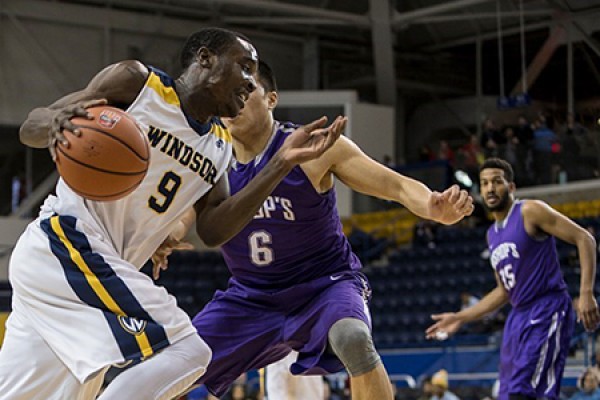 Alex Campbell drives past defenders