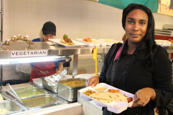 student holding platter of food