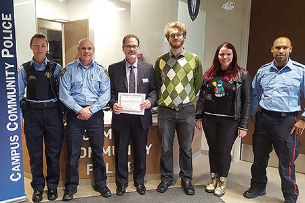 Campus Police officers pose with drama students