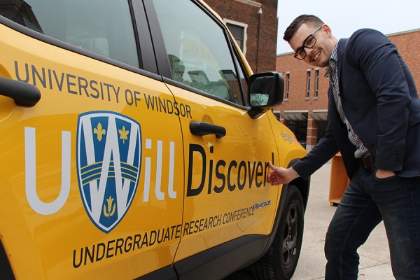 Connor Holowaschuk smooths a vinyl decal