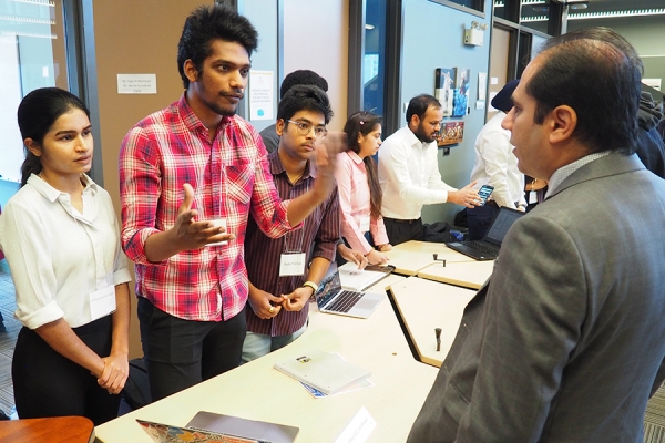 Krishna Telapudi, Kameswara Peddada, and Kartik Peddinti with professor Pooya Moradian Zadeh during Computer Science Demo Day