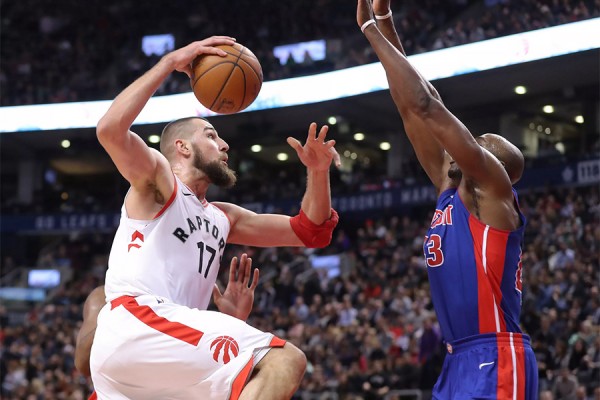 Raptor player scoring over Piston defender