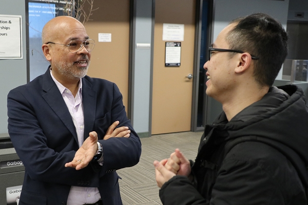 Neil Cesario speaks with a student