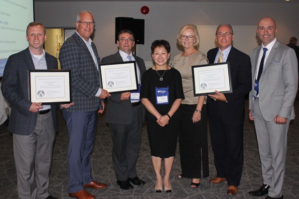 Verna Yiu and Anne Snowdon (centre) congratulate winners in the SCAN Health design competition.