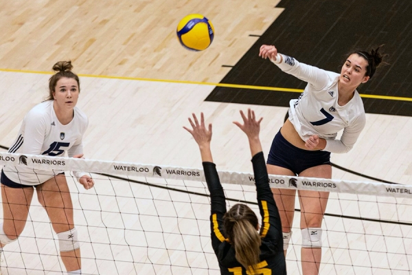 Aryn Markett hitting volleyball over net