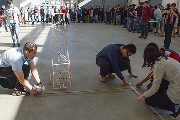 Professor Bill Altenhof measures the distance travelled by a student-designed vehicle driven by potential energy.