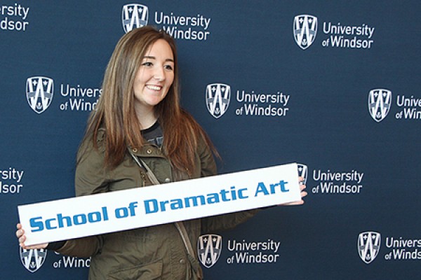 Megan Lovell holding sign &quot;Dramatic Art&quot;