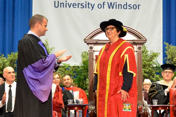 Board of Governors chair William Willis applauds Mary Jo Haddad after her formal installation as Chancellor.