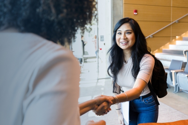 young person shaking hands with prospective employer