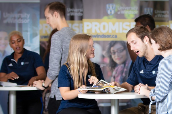 Students and employees speak with families