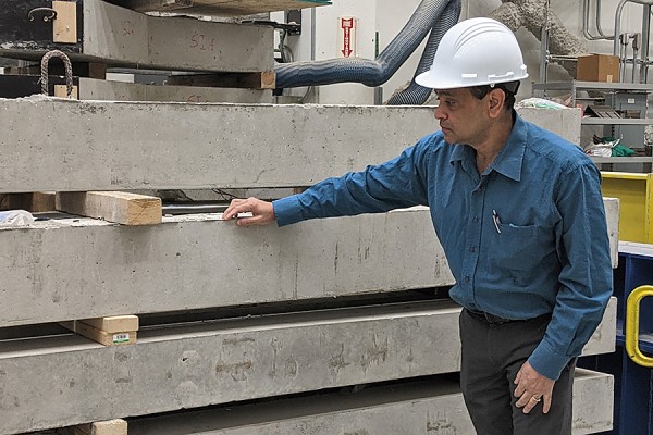 Sreekanta Das looking over concrete structure in lab