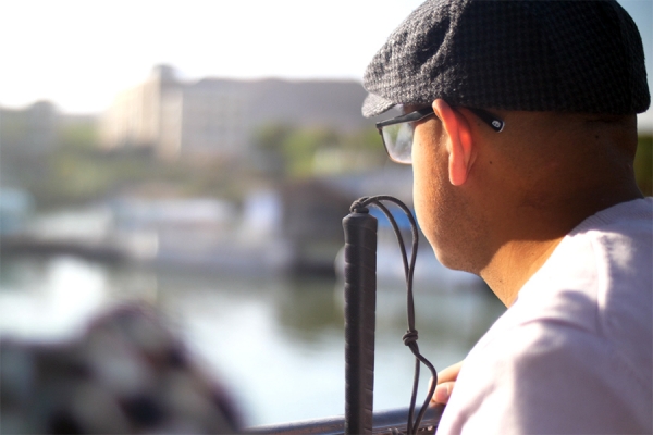 image from Unseen -- man with white cane gazing over urban scene