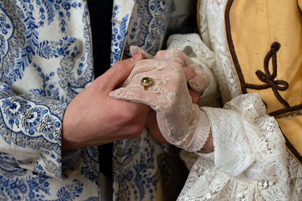 clasped hands with engagement ring