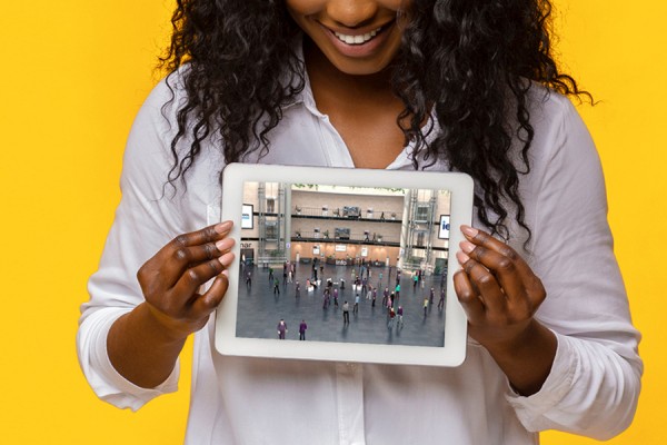 woman holding tablet computer displaying classroom