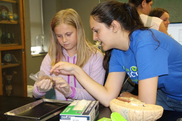 Let’s Talk Science volunteer Nina Milidrag (l.) helped the sixth grader Morgan Curtis (r.) examine a sheep’s brain during St. Anthony Catholic School’s field visit to UWindsor, June 17. 