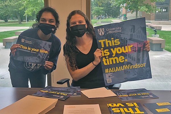 Student ambassador co-ordinator Madhu Yadiki and student ambassador Erin Kenny prepare outreach materials for prospective students.