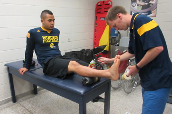 Adam Gaunt readies to tape Tarrance Crawford&#039;s ankle.