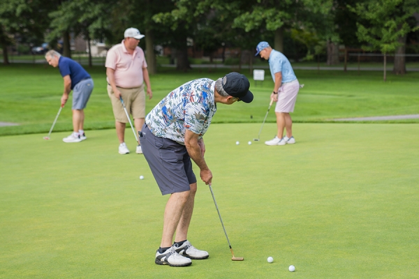 Golfers practising their putts