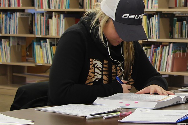 student hitting the books in the library