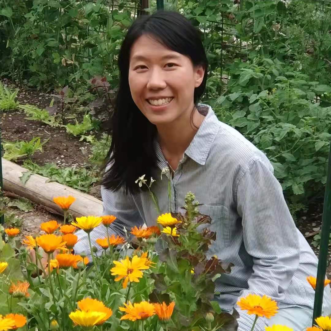 Dr. Khoo in the garden with yellow flowers