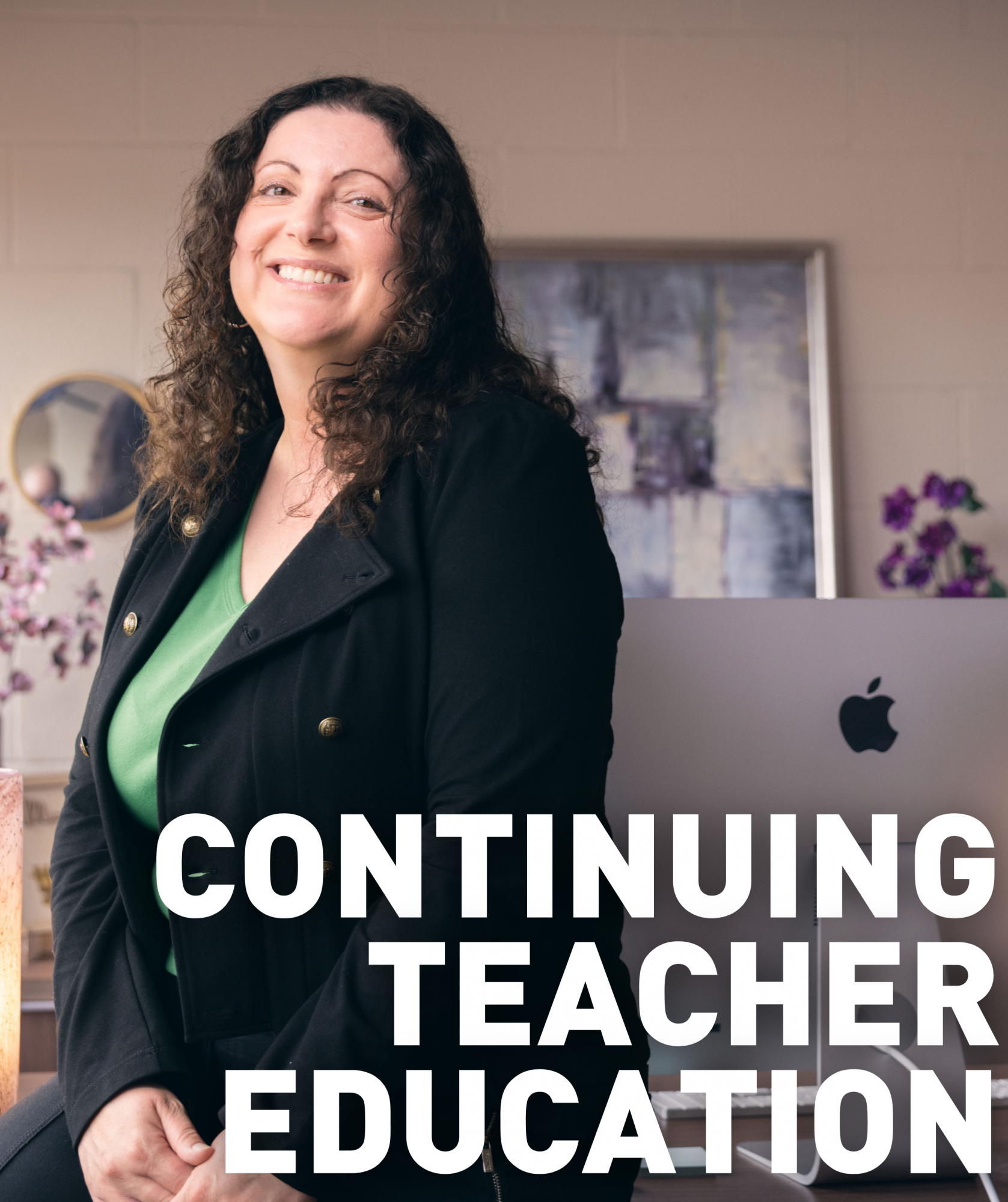 A teacher sitting at their desk smiling. The text "continuing teacher education" written on the image