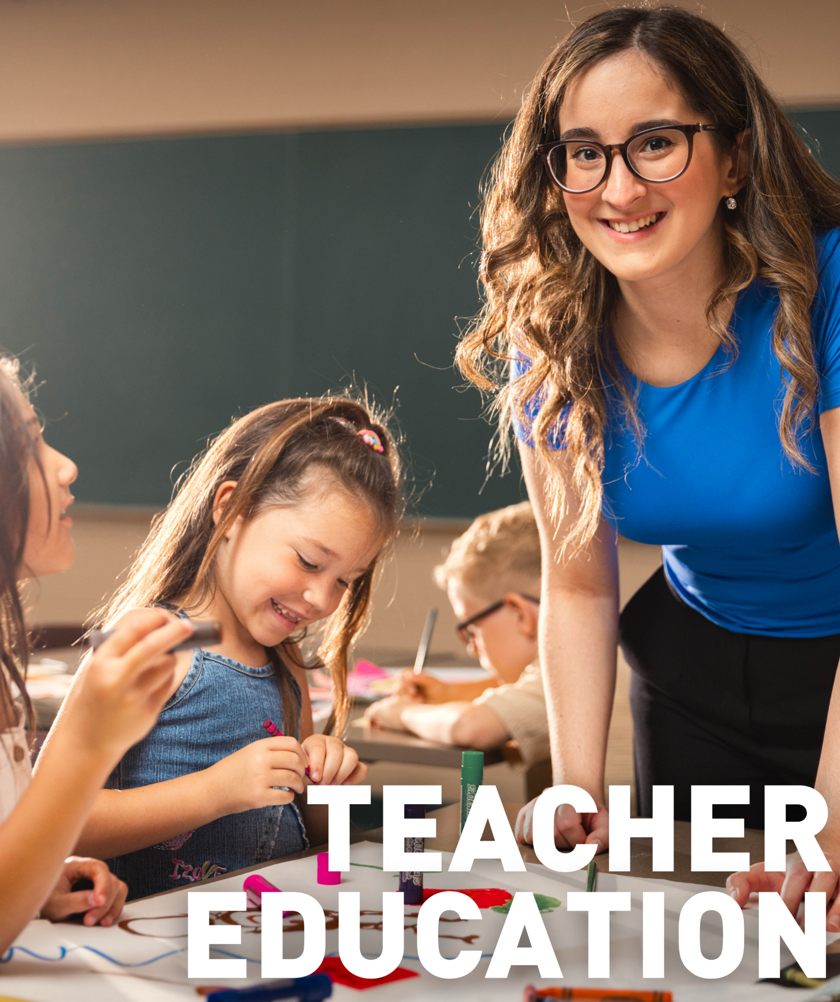 an undergraduate student teaching a lesson in a classroom with elementary school aged children. The text "undergraduate" on the image