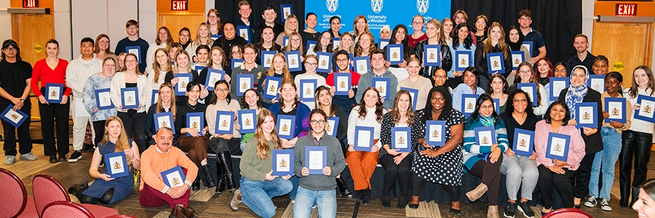 Group photo of students holding their Dean's Honour Roll award