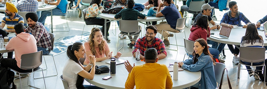 Students chat at tables