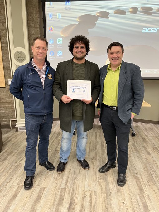 Ali Mokdad receiving the Lum Clark PhD Award from Dr. Trevor Pitcher and Dr. Mike McKay. 