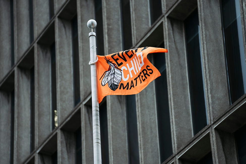 Orange Shirt Day flag on a pole