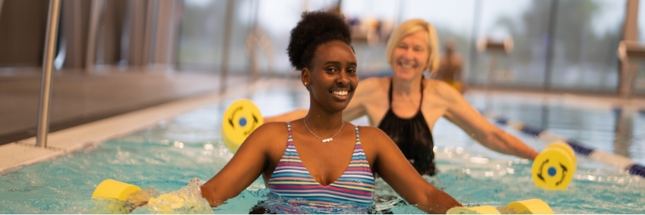 two people in a pool smiling