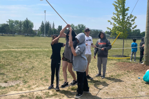 Participants pulling on a rope during a challenge courage activity.