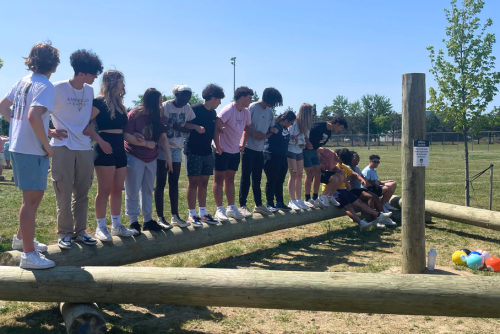 Participants on the challenge course triangle element.