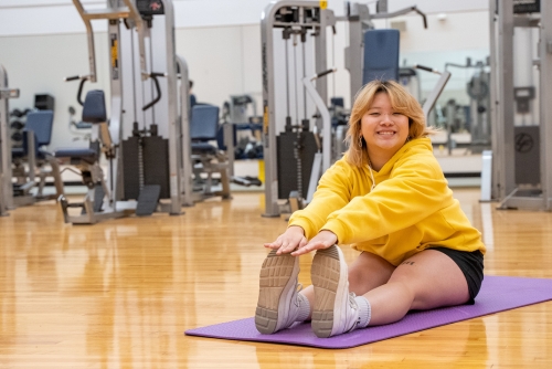 Member stretches in multipurpose room