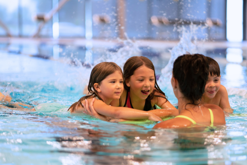 Children smiling during swimming lessons.