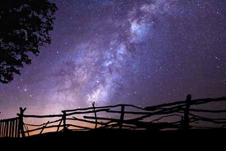 Wyoming night sky and wood rail fence