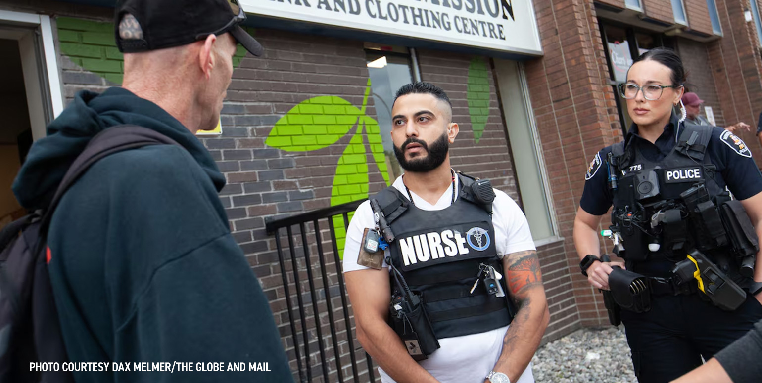 Windsor Regional Hospital nurse Abbas Haidar and Const. Jordyn Thompson speak with a citizen