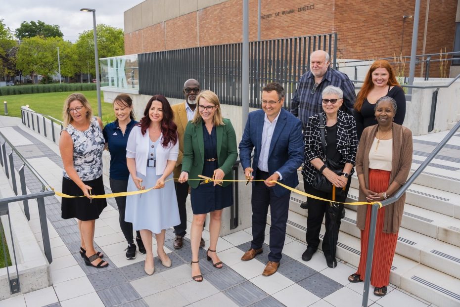 A group poses for a ribbon cutting