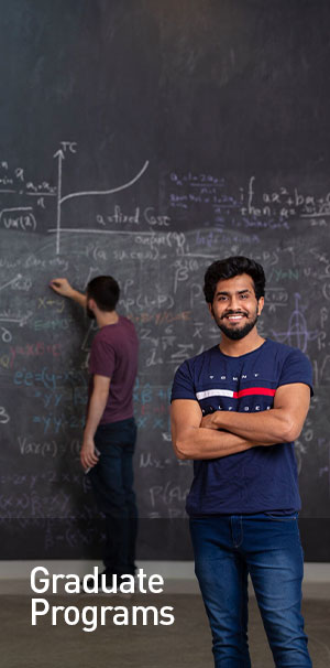 Man in blue shirt arms crossed and smiling at camera 