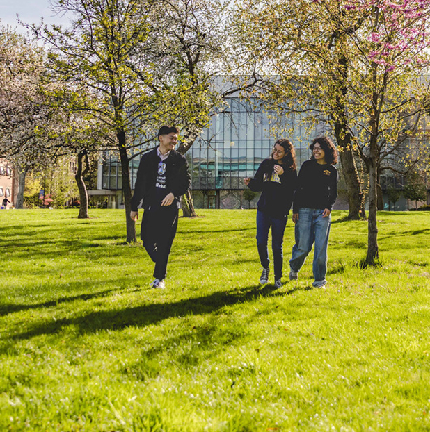 students walking across campus green