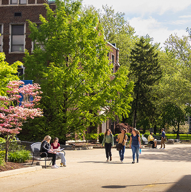 students walking past Dillon Hall