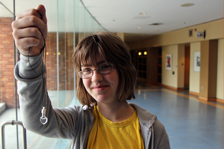 girl holding up pendant