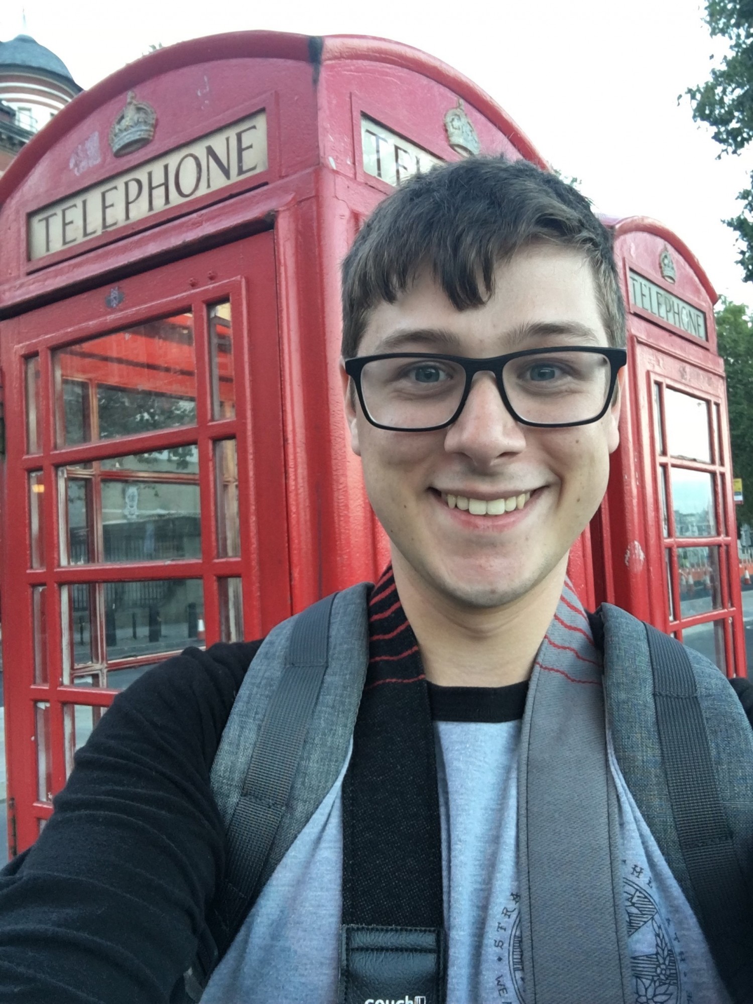 Jamie at a red phone booth in the UK