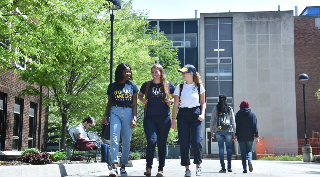 three UWindsor students walking outside of the CAW student centre