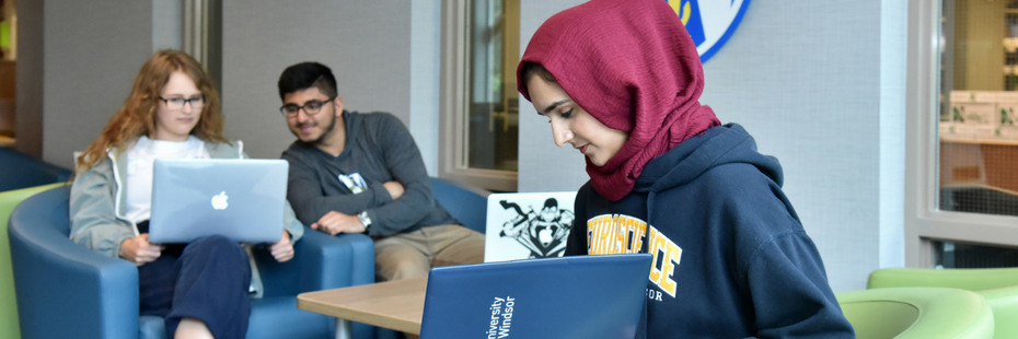 Students working on their laptops in the Hum