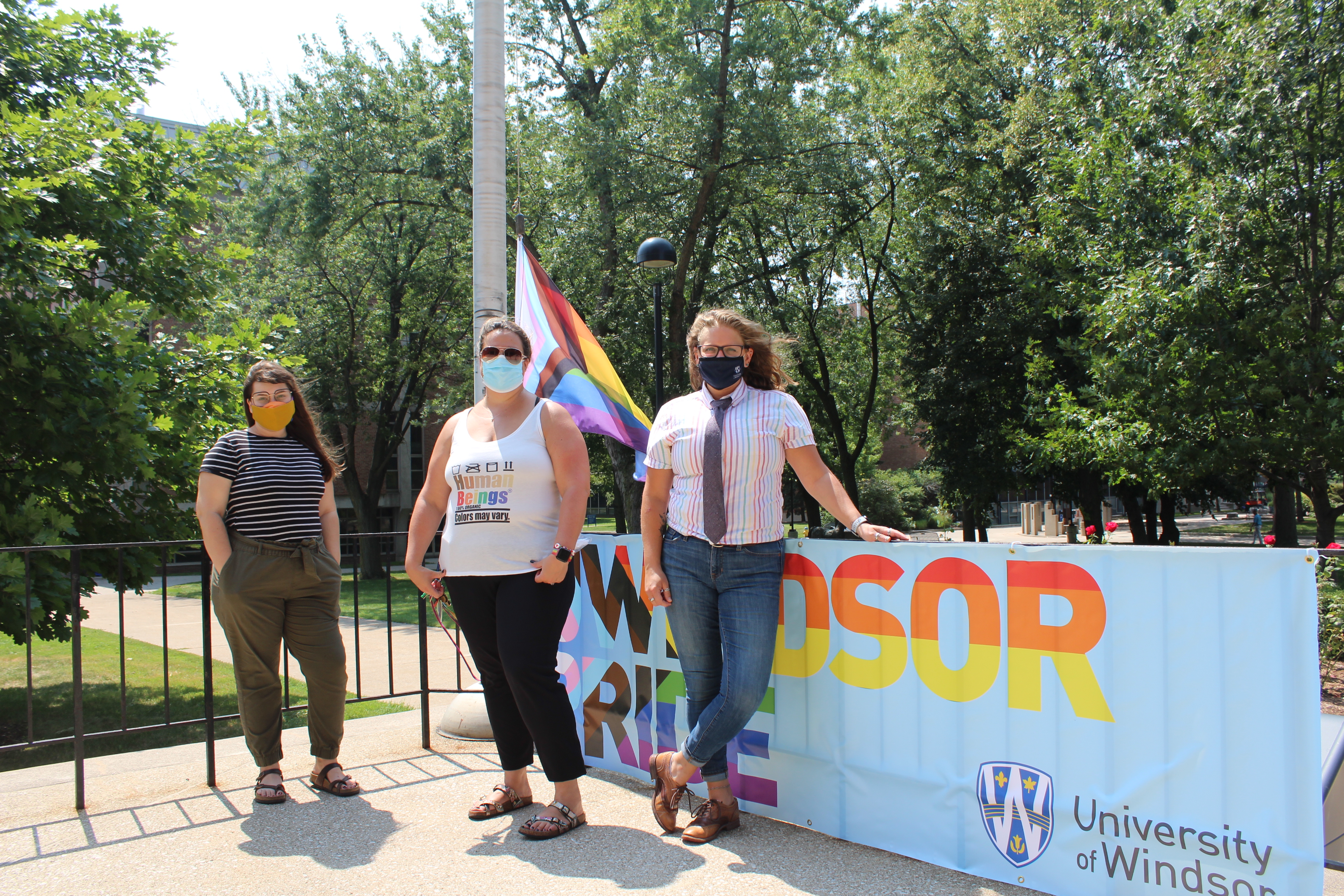 members of UWin Pride committee pose with Pride Flag and banner