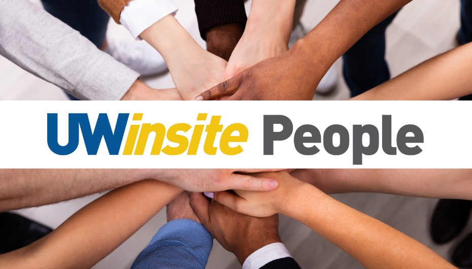 Group of people stacking hands with UWinsite People written across